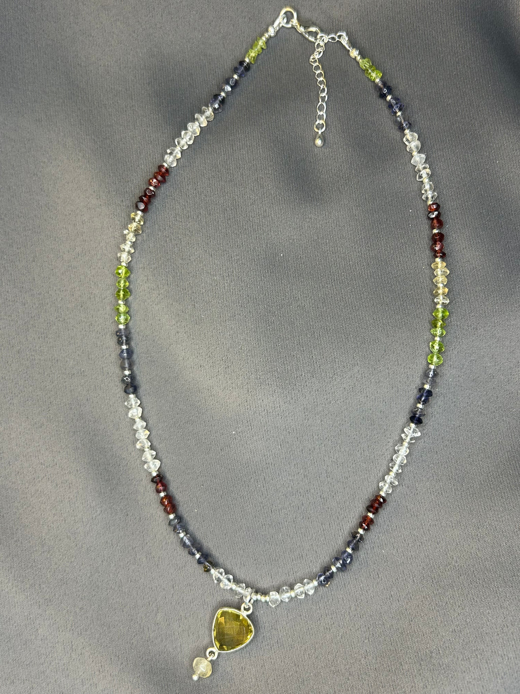 Necklace with multicolored beads on a gray background