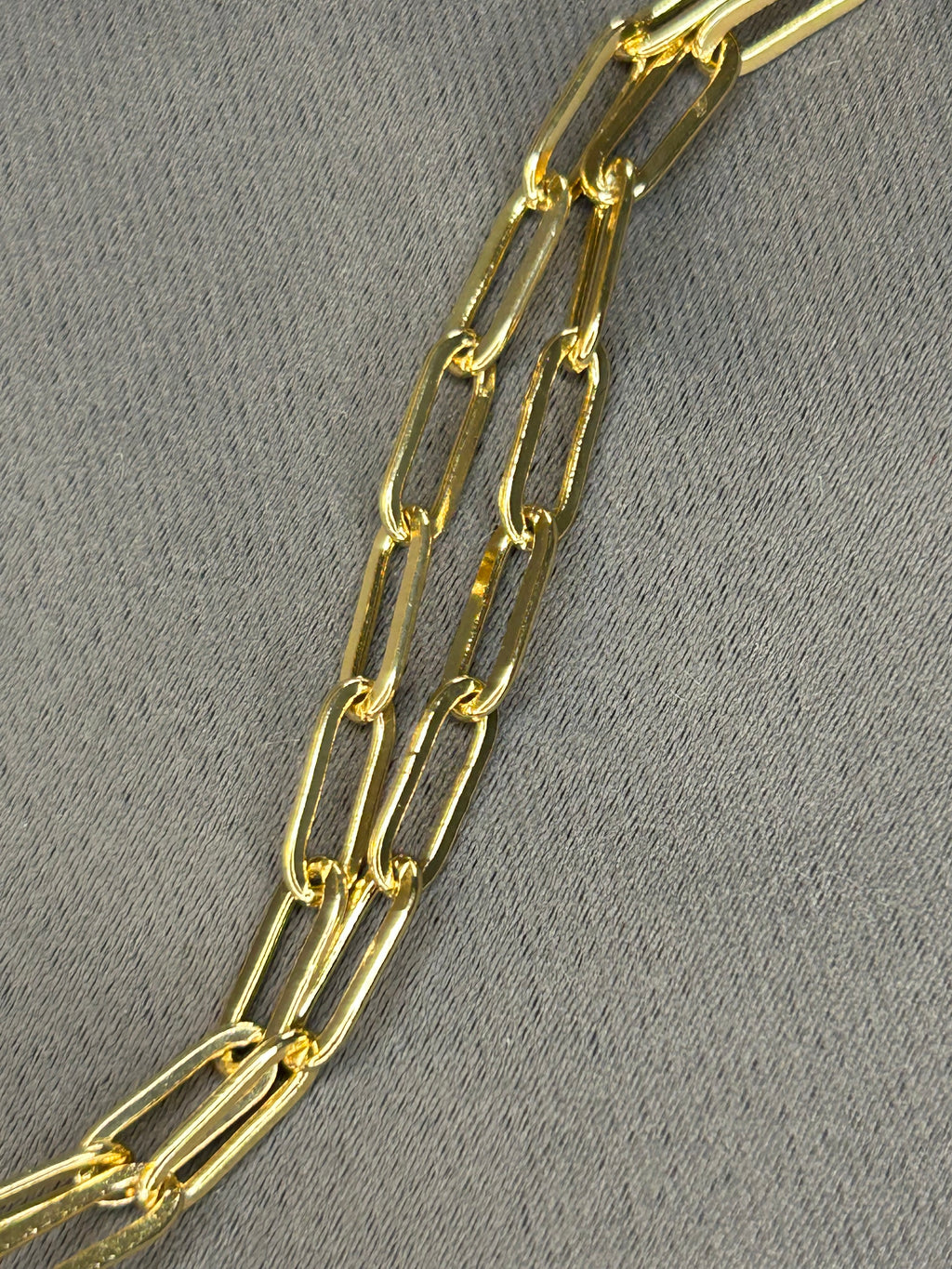 Gold chain on a gray textured background