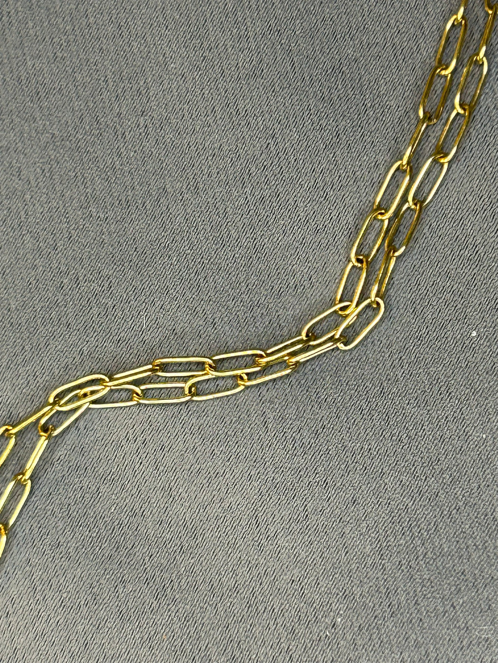 Gold chain on a gray textured background