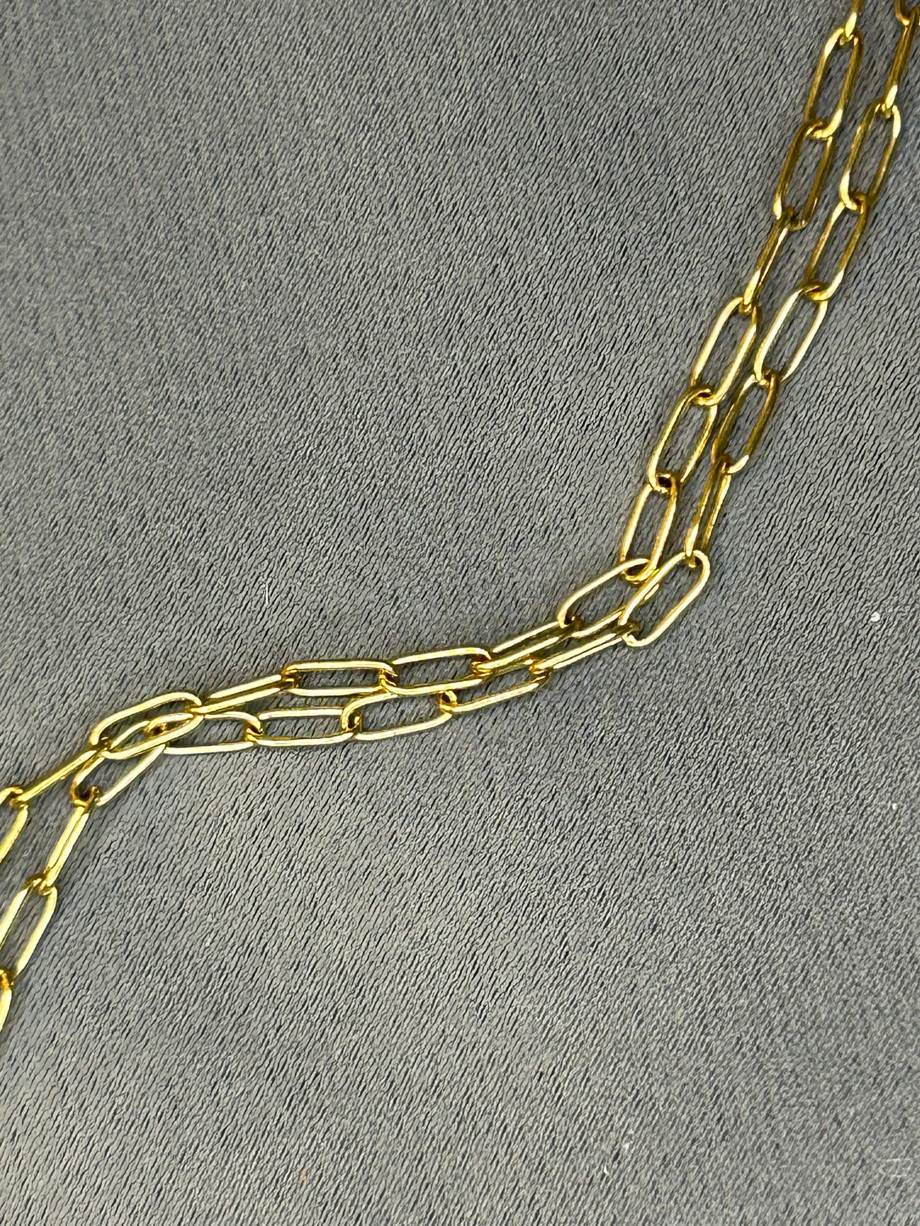Gold chain on a gray textured background