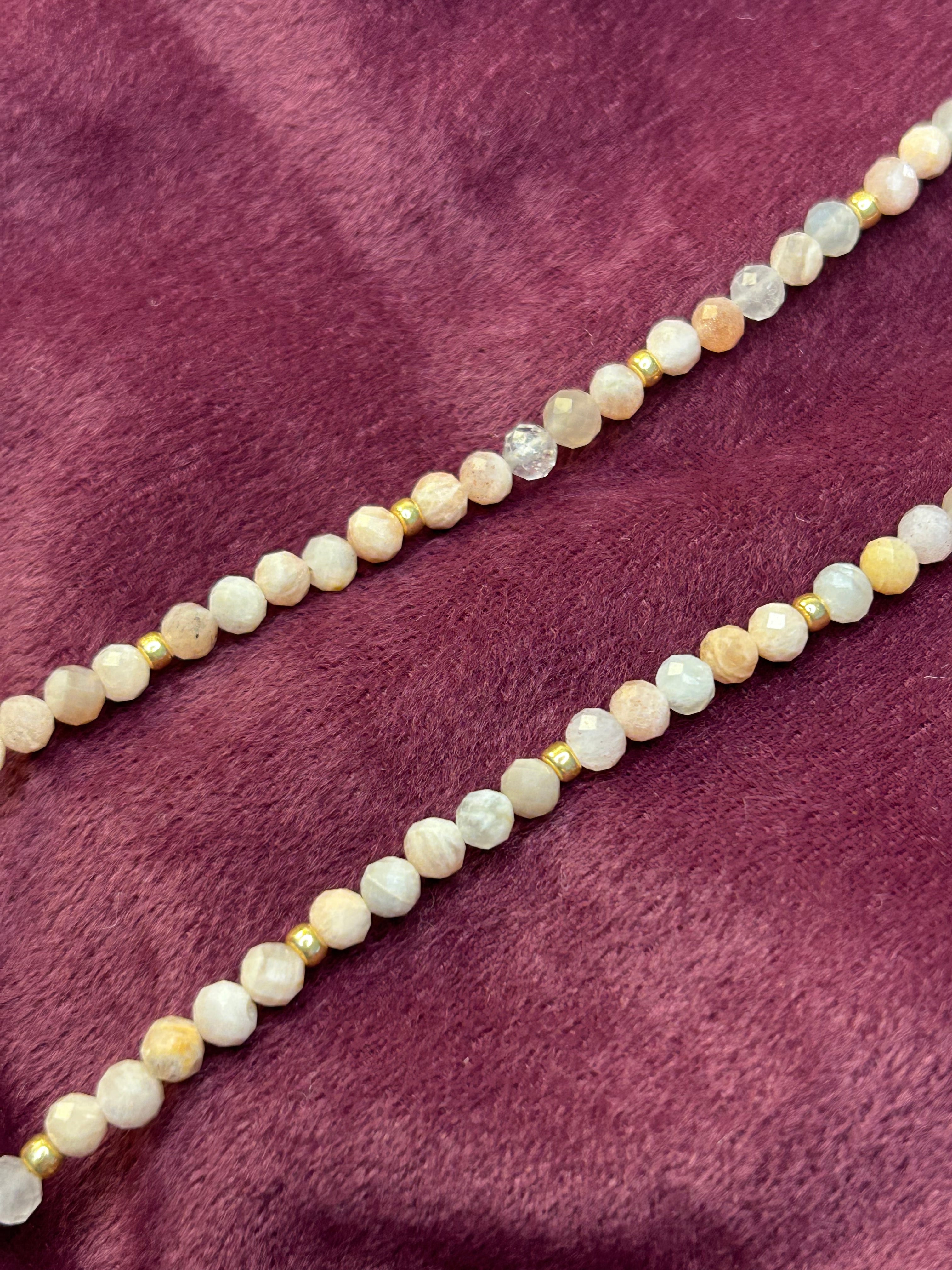 Necklace with small beads on a purple fabric background