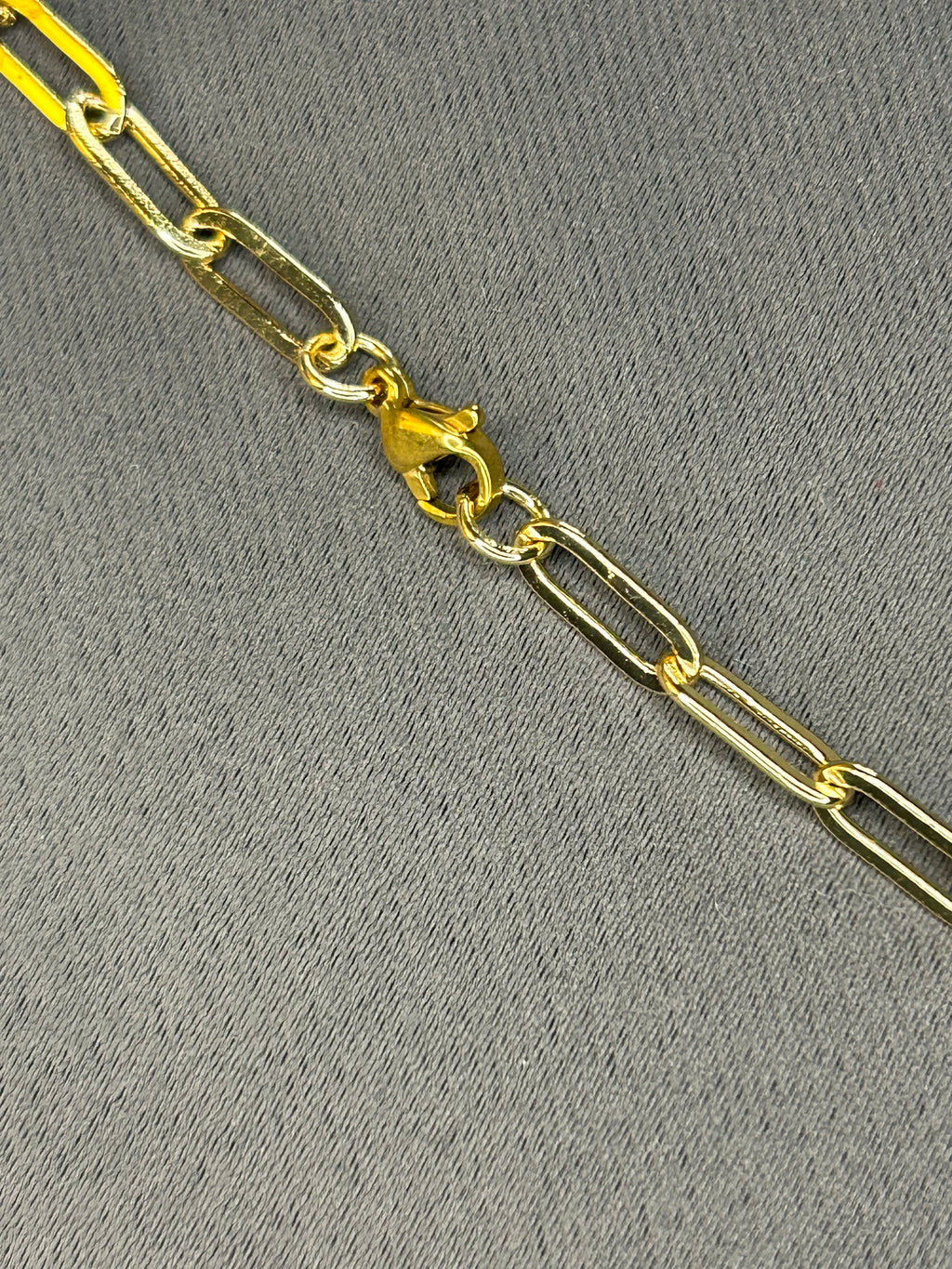 Gold chain on a gray textured background