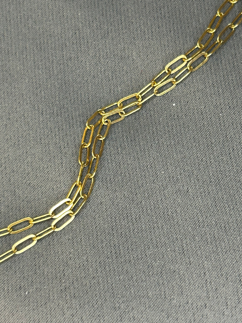 Gold chain on a gray textured background