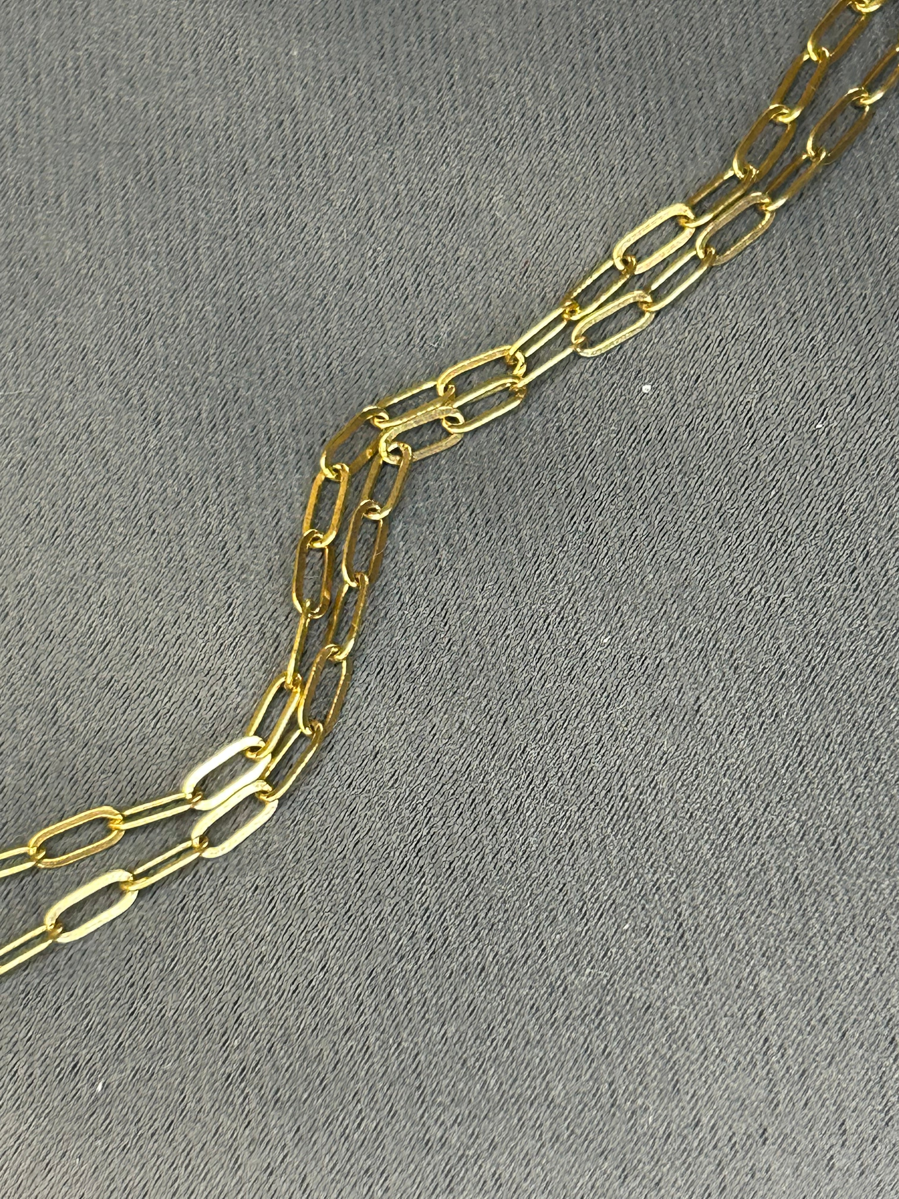 Gold chain on a gray textured background