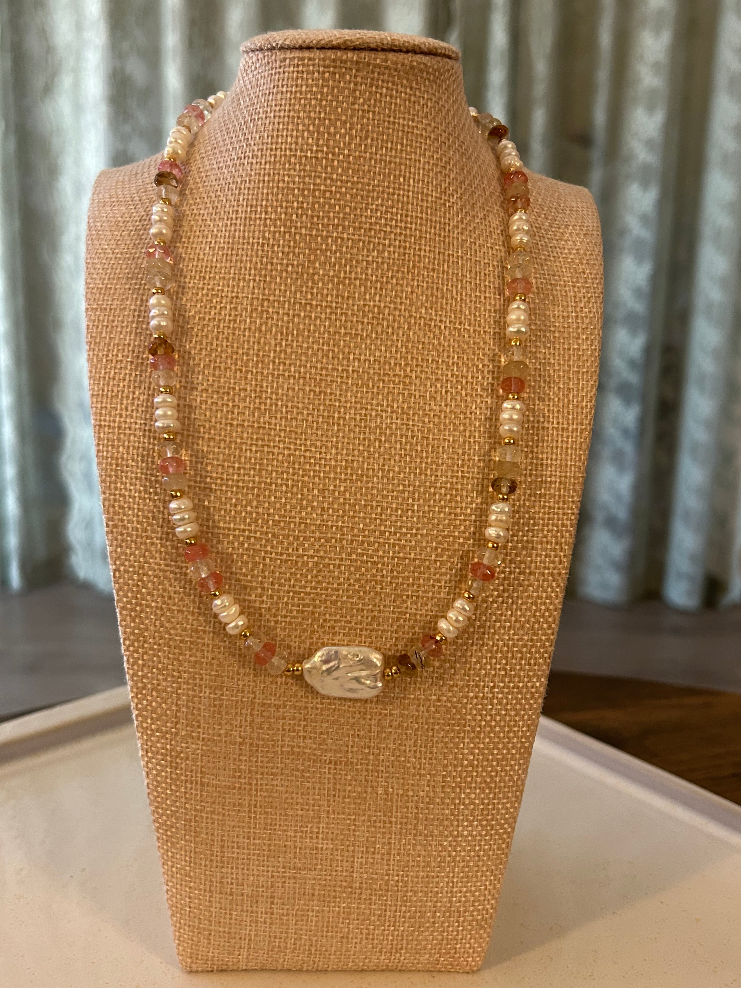 Beaded necklace on a brown jewelry display