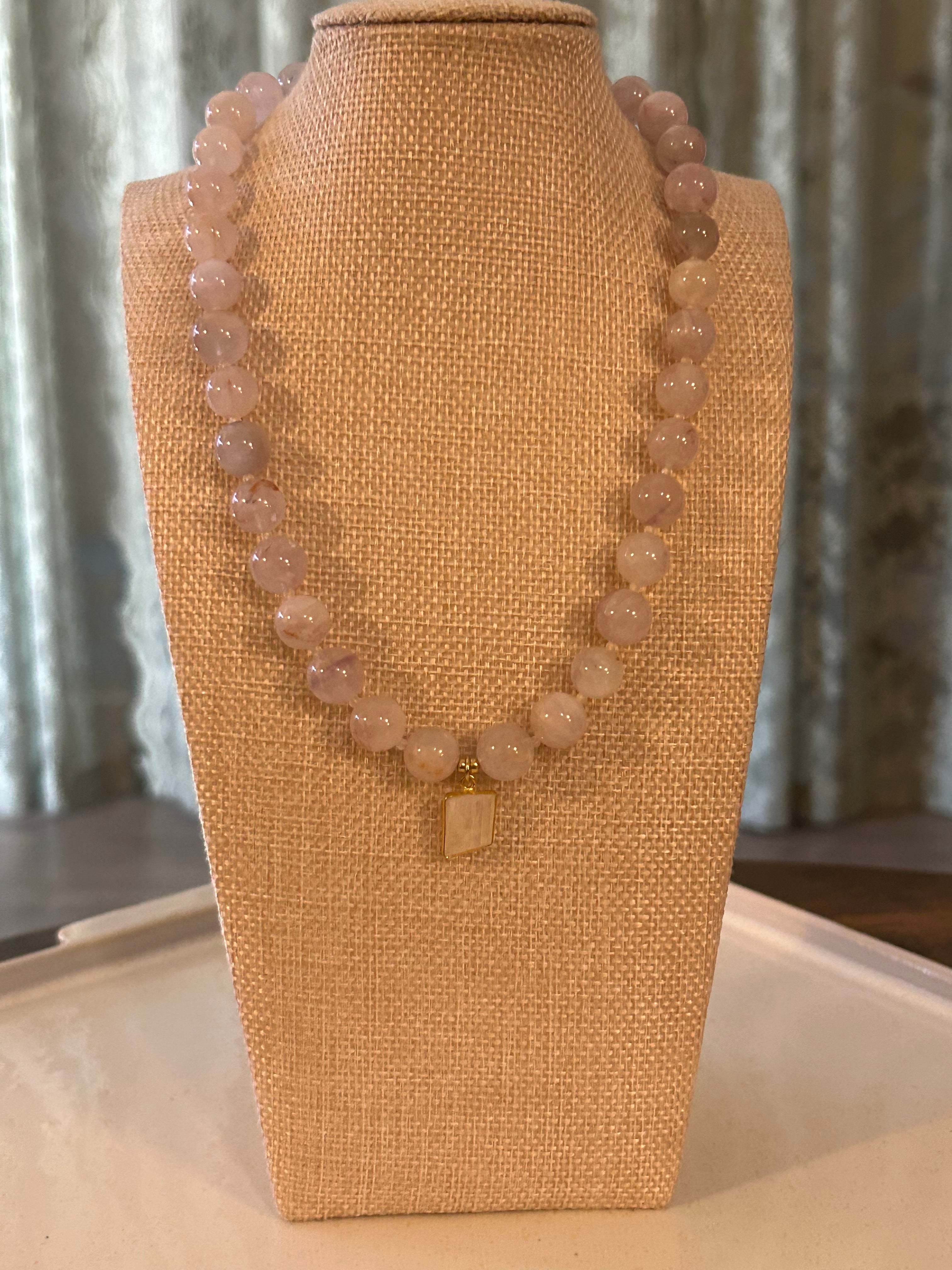 Necklace on a tan fabric display