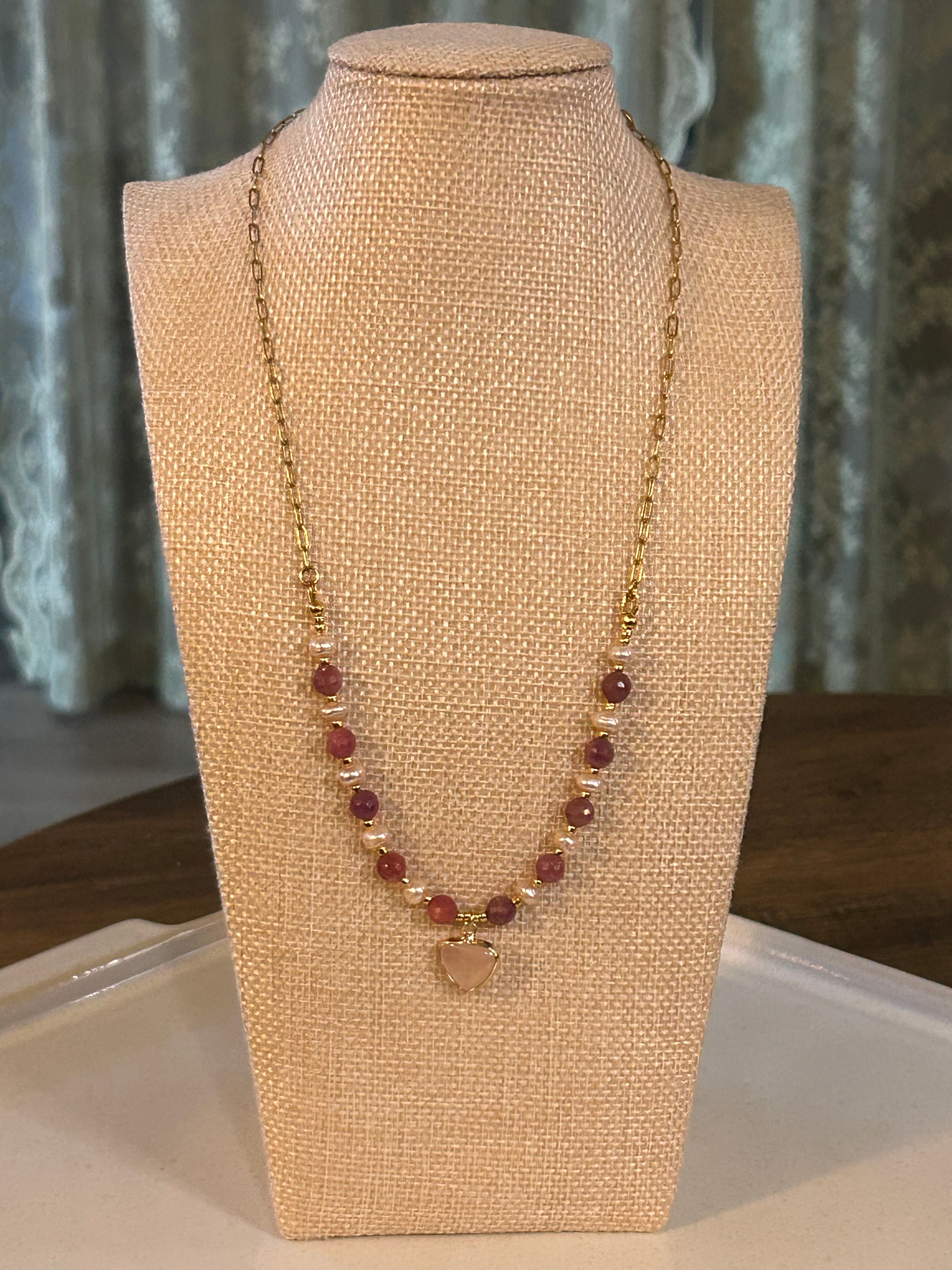 Necklace on a beige mannequin bust with a neutral background