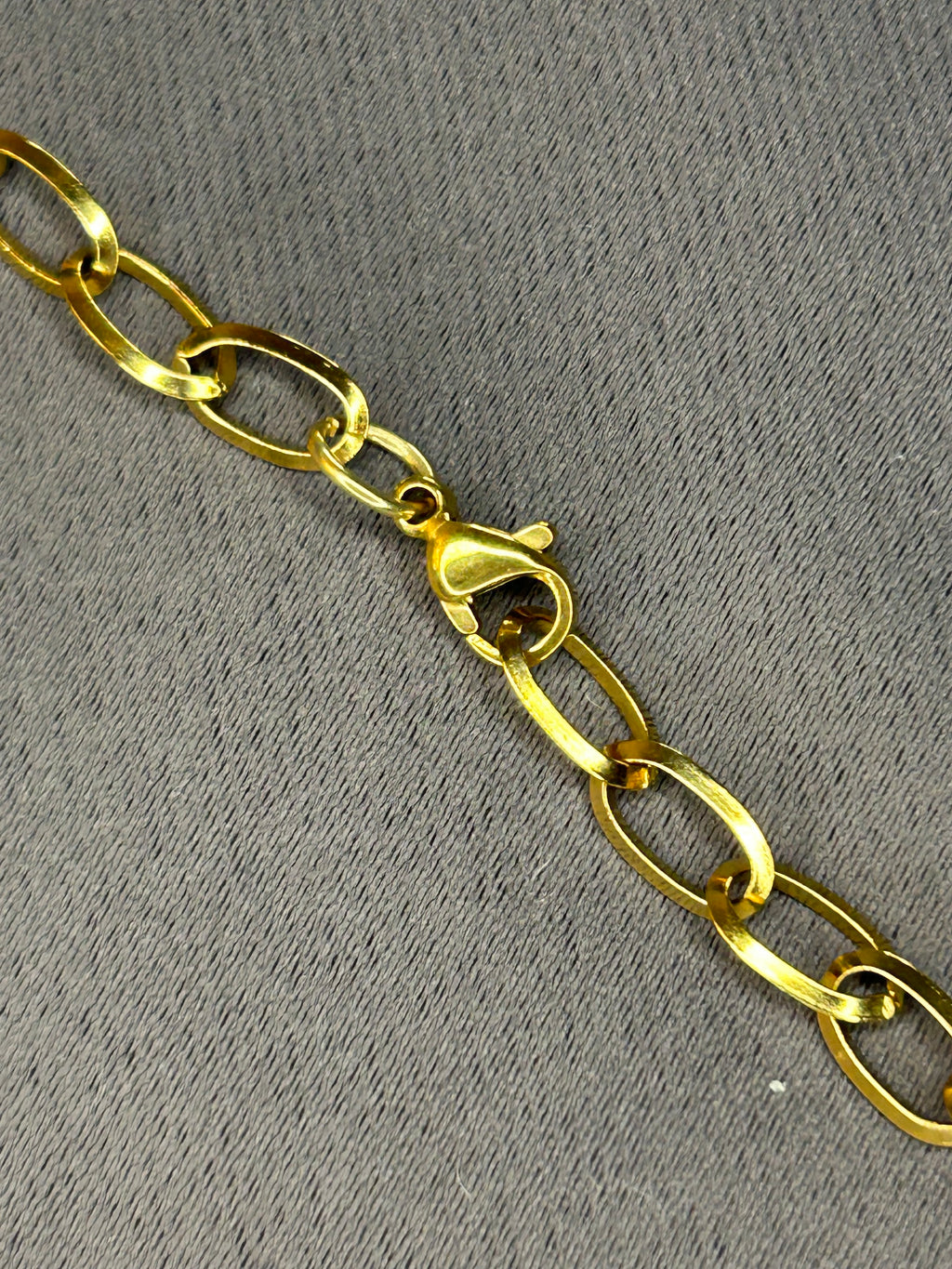 Gold chain on a gray textured background