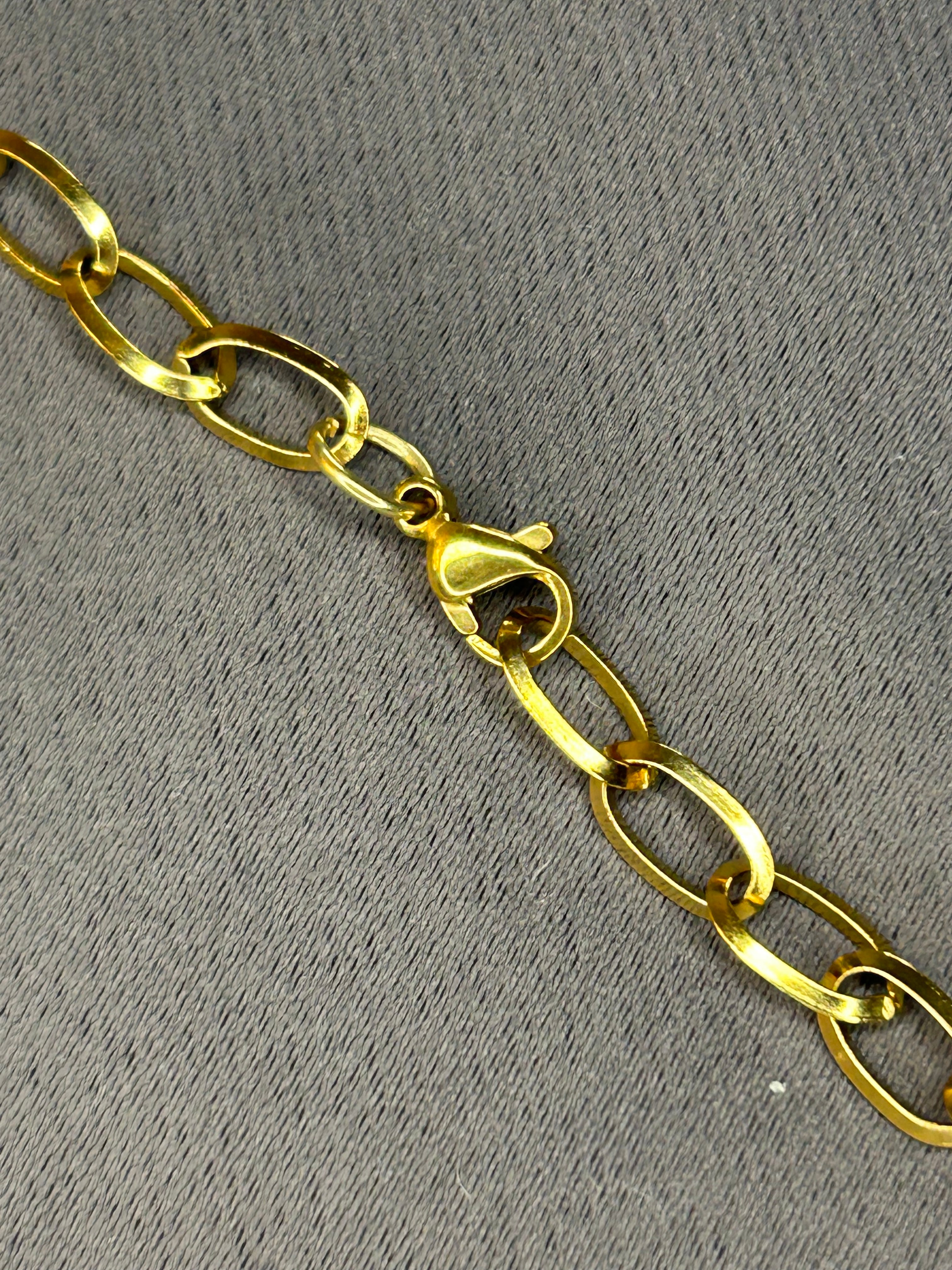 Gold chain on a gray textured background