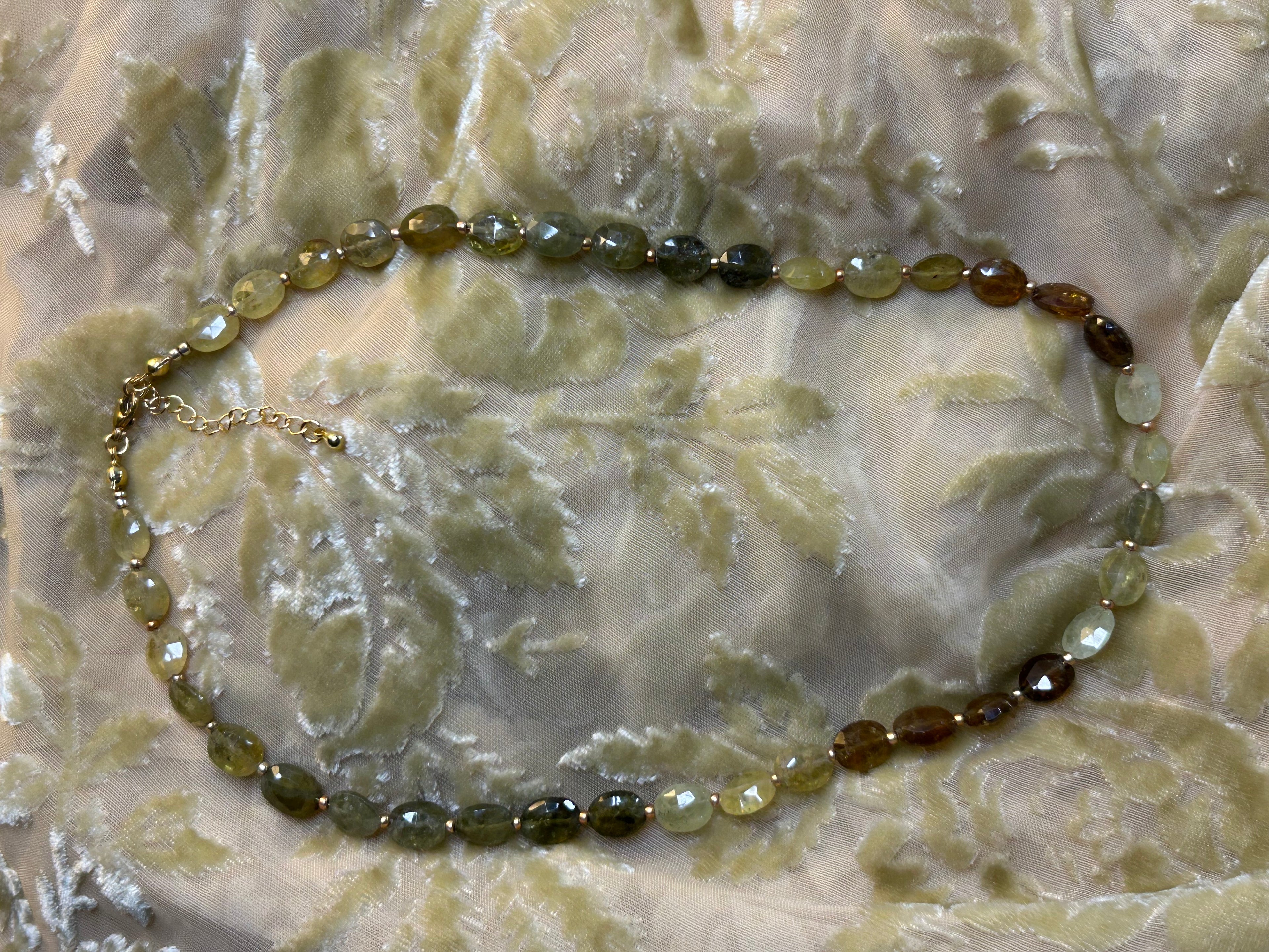 Necklace with beaded chain on a textured surface