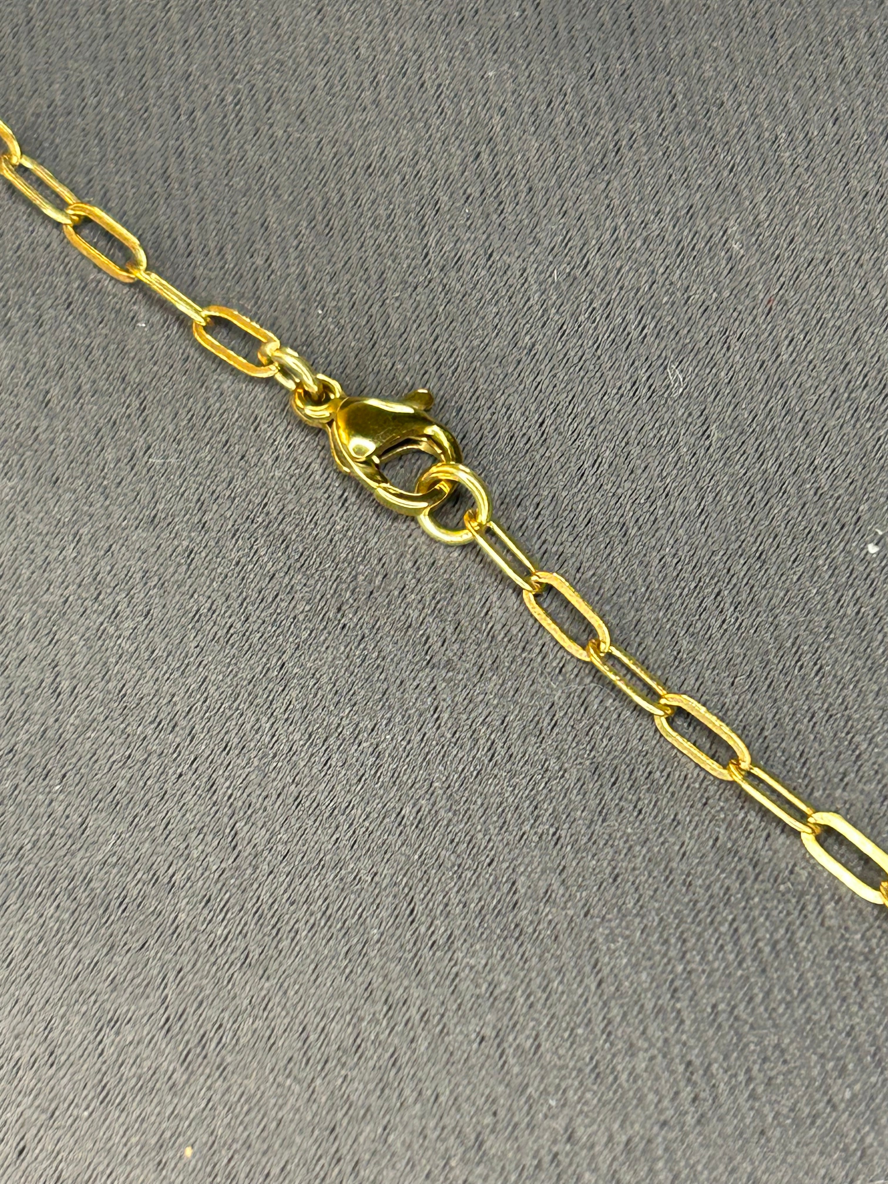 Gold chain with a clasp on a gray background