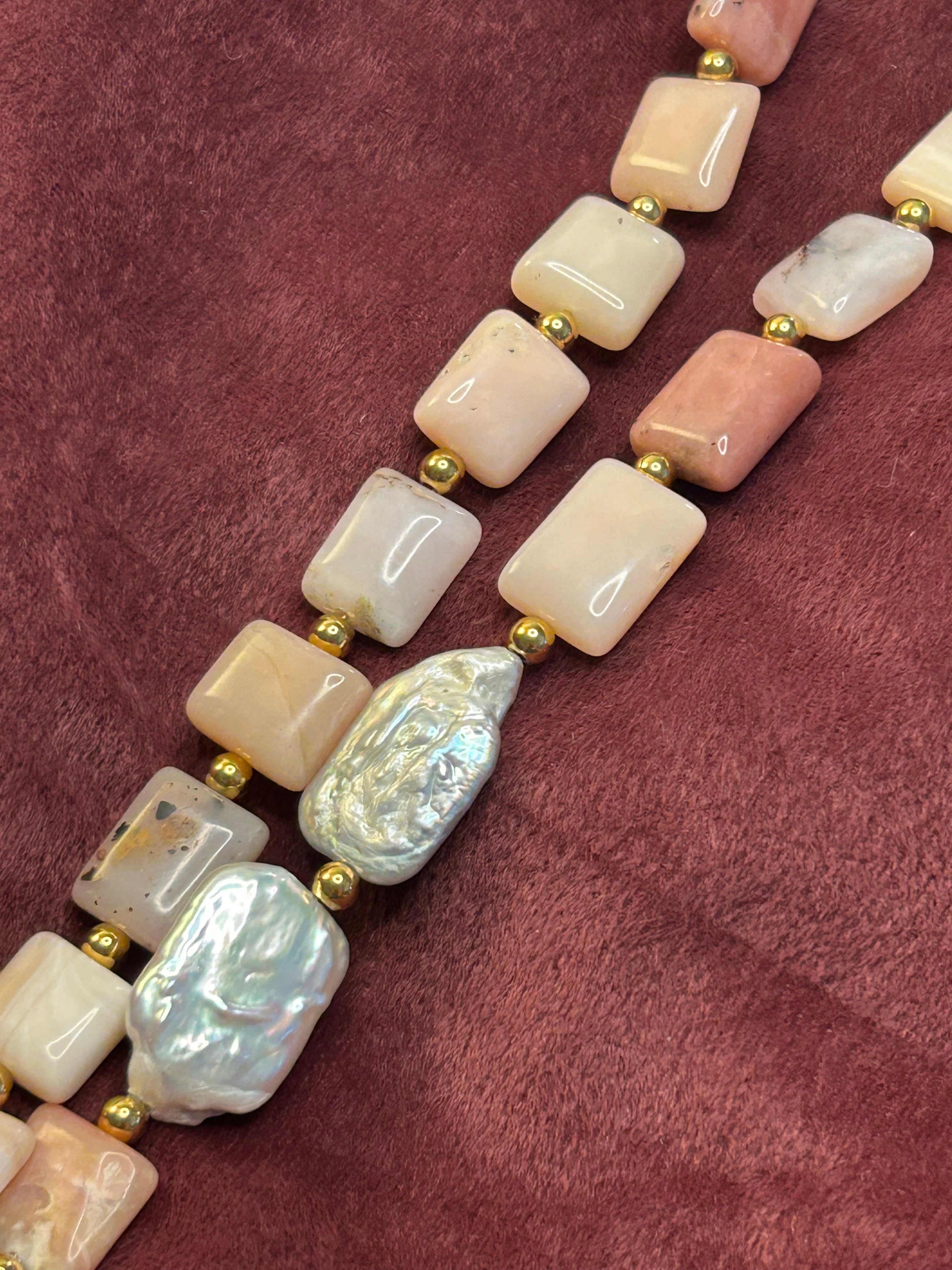 Necklace with pink and white beads on a maroon fabric background