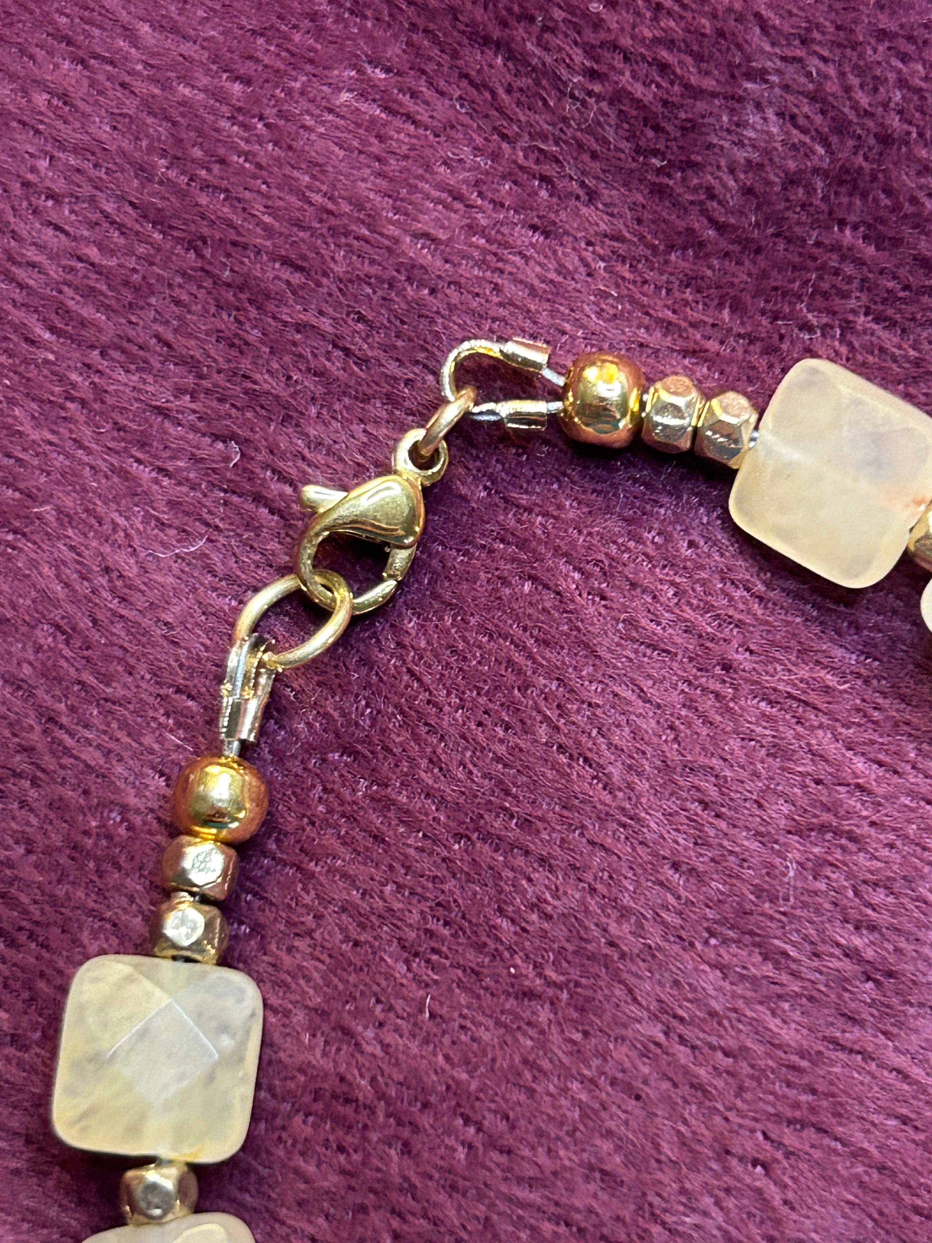 Necklace with beads on a purple textured background