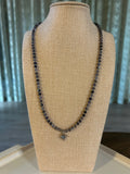 Necklace on a mannequin bust with a neutral background