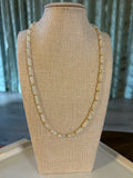 Opal beaded necklace on a beige mannequin arm