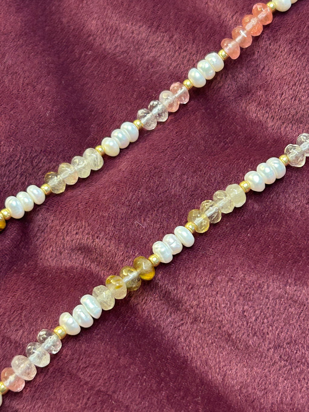 Beaded necklace on a purple fabric background