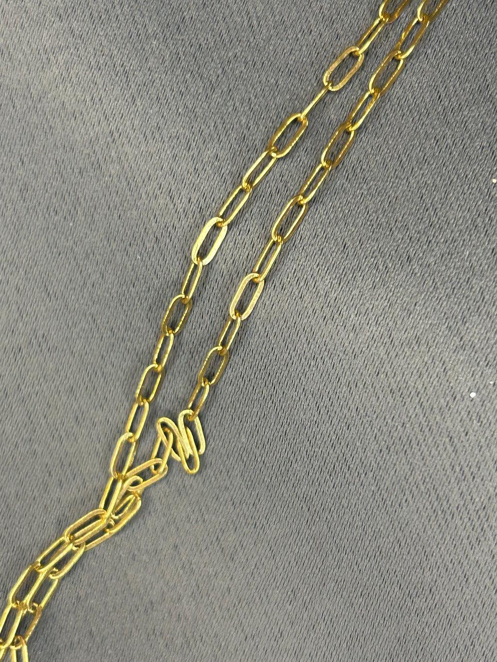 Gold chain on a gray background