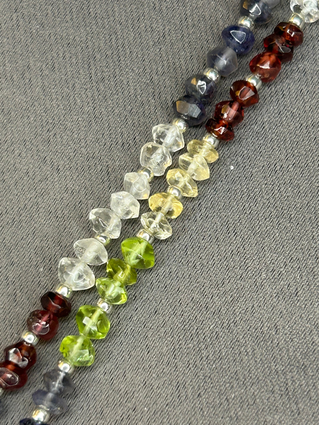 Beaded necklace with multicolored beads on a gray surface