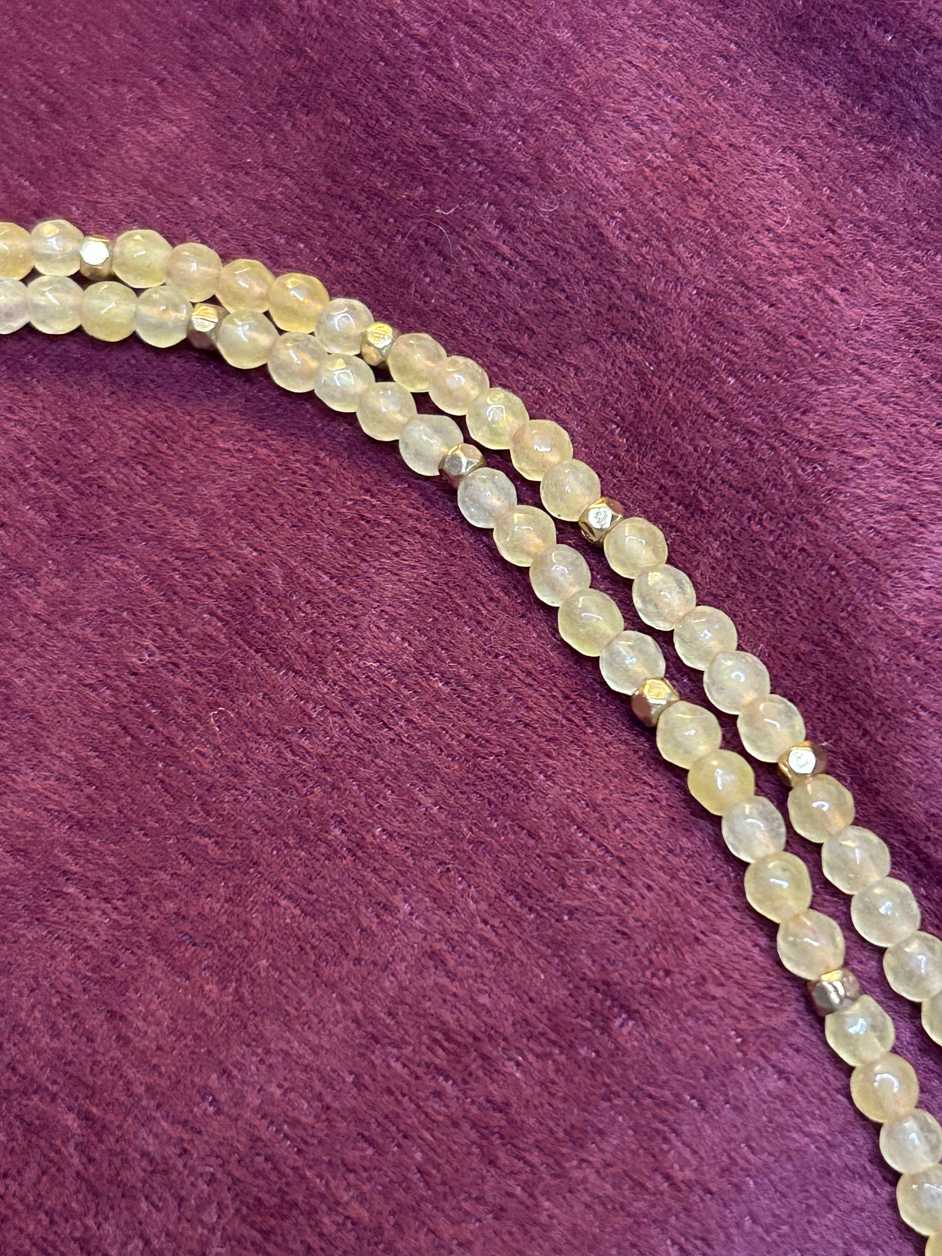 Beaded necklace on a purple fabric background